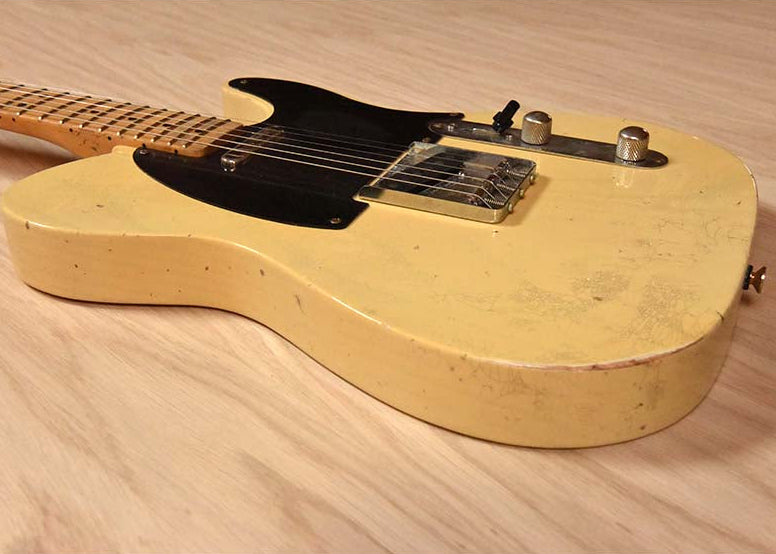 Blonde Mike Hobbs electric guitar on a wooden surface