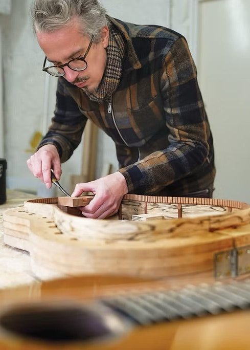 Leddington Luthier working on a guitar in a Crafted Guitars workshop